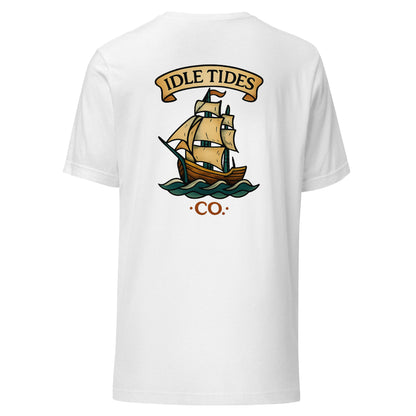 White tee with Idle Tides ship graphic on back and crest badge on front