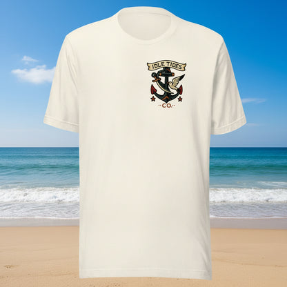 Sand tee with Idle Tides ship graphic on back and crest badge on front