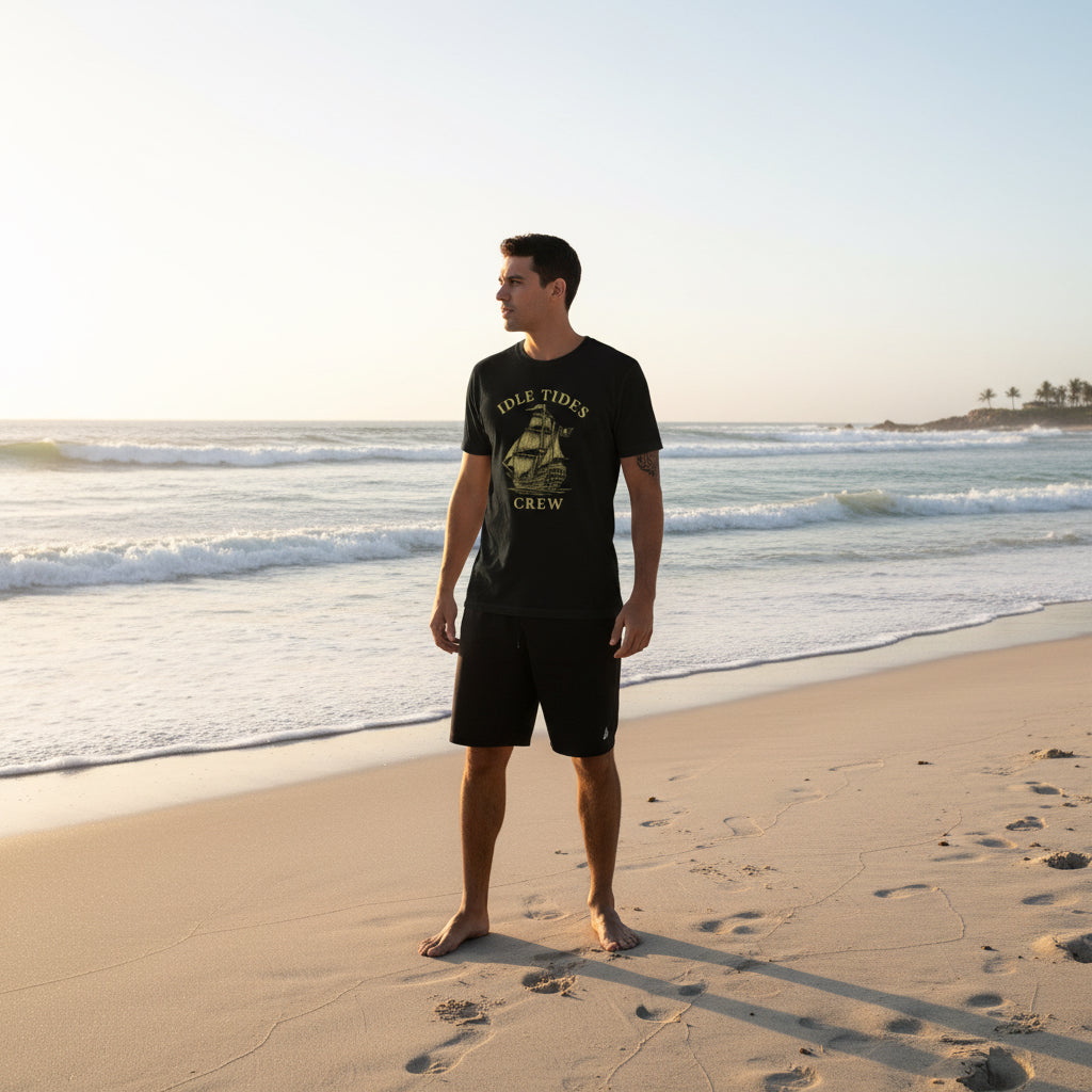 Idle Tides Co Legendary Pirate Frigate crewneck tee in black featuring detailed sailing ship illustration with full masts and rigging; relaxed fit, nautical heritage design.